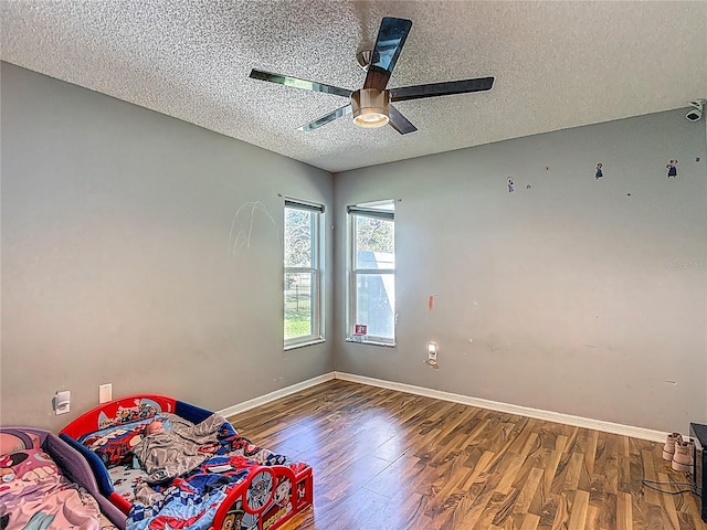 173 Portland Ave, Spring Hill, FL 34606 - unfurnished room with a textured ceiling, wood finished floors, and a ceiling fan