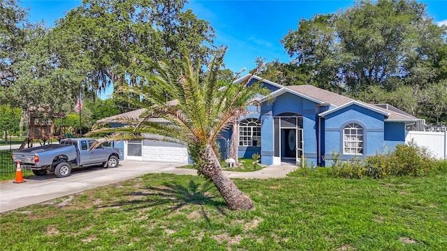 173 Portland Ave, Spring Hill, FL 34606 - view of front of home featuring driveway, a garage, and stucco siding