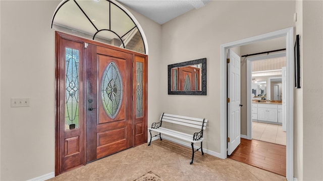 5819 Hollyhock Dr, Lakeland, FL 33813 - foyer featuring light tile patterned floors and baseboards