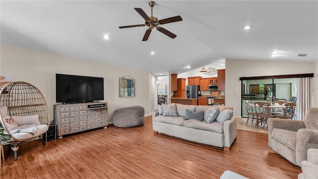 5819 Hollyhock Dr, Lakeland, FL 33813 - living room with lofted ceiling, a ceiling fan, and light wood finished floors