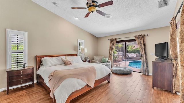 5819 Hollyhock Dr, Lakeland, FL 33813 - bedroom with access to exterior, wood finished floors, a textured ceiling, high vaulted ceiling, and a ceiling fan