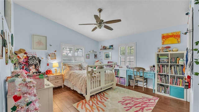 5819 Hollyhock Dr, Lakeland, FL 33813 - bedroom with vaulted ceiling, wood finished floors, ceiling fan, and a textured ceiling