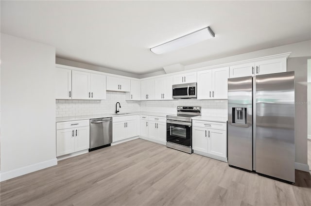 2633 Keysville Dr, Lithia, FL 33547 - kitchen with appliances with stainless steel finishes, tasteful backsplash, white cabinets, and light countertops