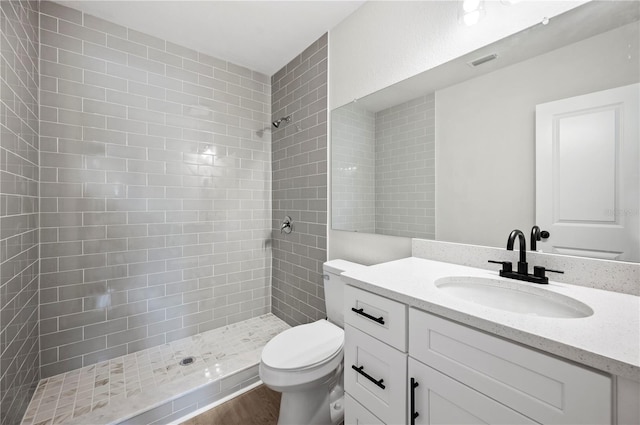 2633 Keysville Dr, Lithia, FL 33547 - bathroom with vanity, tiled shower, and wood finished floors