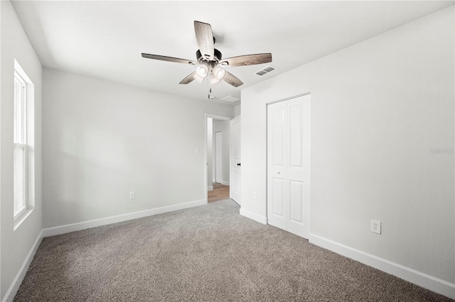 2633 Keysville Dr, Lithia, FL 33547 - unfurnished bedroom with carpet flooring, a closet, ceiling fan, and multiple windows