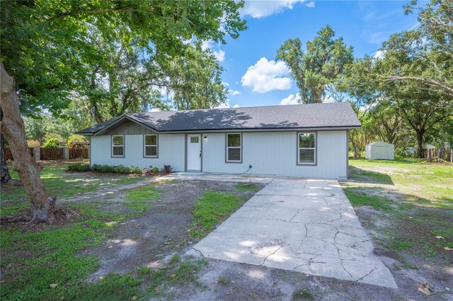 2633 Keysville Dr, Lithia, FL 33547 - ranch-style house featuring a storage shed, driveway, and roof with shingles