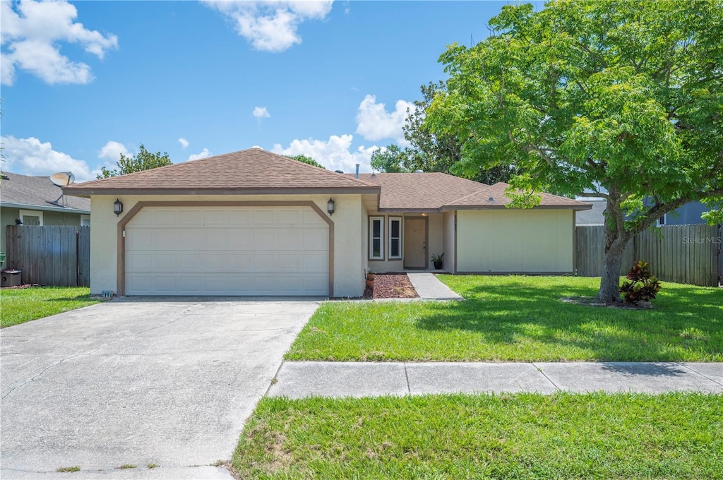 1081 Sunshine Way SW, Winter Haven, FL 33880 - single story home with stucco siding, a garage, and driveway