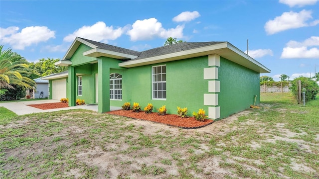 4515 Starfish Ave, Sebring, FL 33870 - view of home's exterior featuring stucco siding, a garage, driveway, and roof with shingles