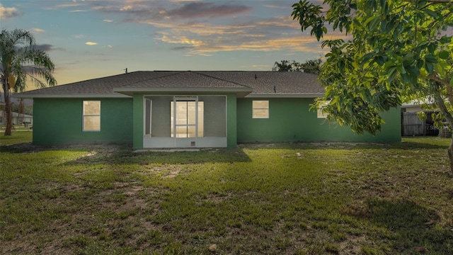 4515 Starfish Ave, Sebring, FL 33870 - rear view of house with a lawn, stucco siding, a shingled roof, and a sunroom