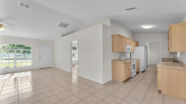 4515 Starfish Ave, Sebring, FL 33870 - kitchen featuring white appliances, light brown cabinetry, light countertops, light tile patterned floors, and vaulted ceiling