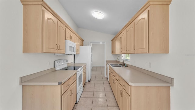 4515 Starfish Ave, Sebring, FL 33870 - kitchen featuring light brown cabinetry, white appliances, light countertops, light tile patterned floors, and lofted ceiling