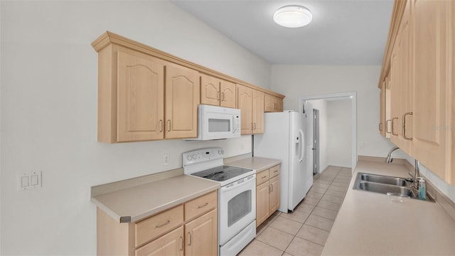 4515 Starfish Ave, Sebring, FL 33870 - kitchen with white appliances, light brown cabinets, light tile patterned floors, and light countertops