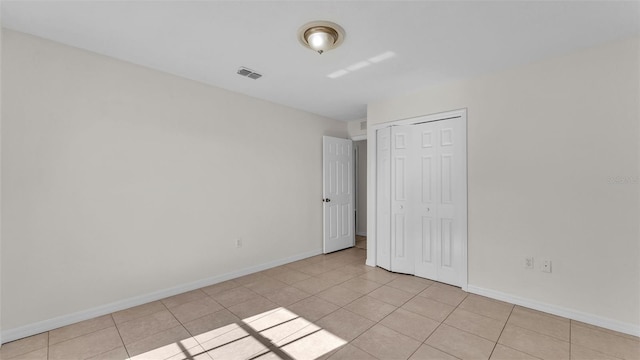 4515 Starfish Ave, Sebring, FL 33870 - unfurnished bedroom with light tile patterned flooring and a closet