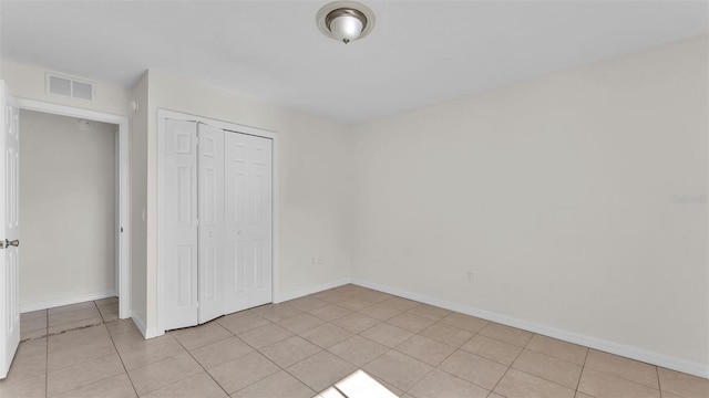 4515 Starfish Ave, Sebring, FL 33870 - unfurnished bedroom with light tile patterned flooring and a closet