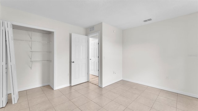 4515 Starfish Ave, Sebring, FL 33870 - unfurnished bedroom featuring a closet and light tile patterned flooring