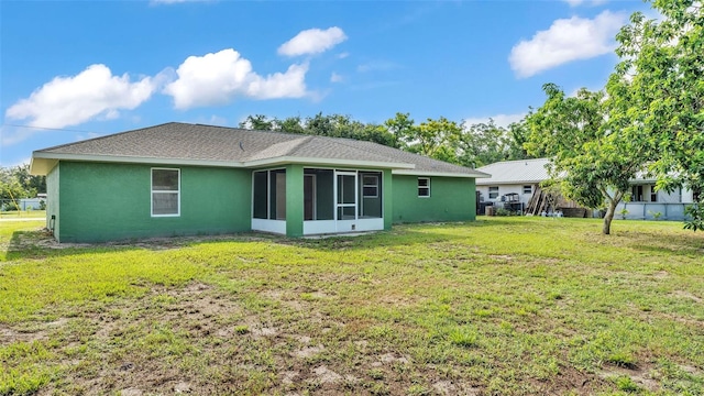 4515 Starfish Ave, Sebring, FL 33870 - back of house featuring stucco siding, a sunroom, a yard, and roof with shingles