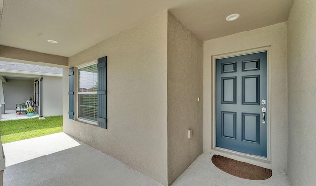 4143 Red Fern Ln, Lakeland, FL 33811 - view of exterior entry featuring stucco siding