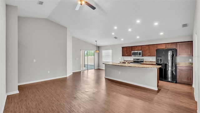 4143 Red Fern Ln, Lakeland, FL 33811 - kitchen with stainless steel appliances, lofted ceiling, ceiling fan, a kitchen island with sink, and wood finished floors