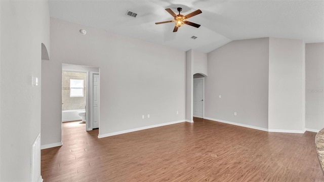 4143 Red Fern Ln, Lakeland, FL 33811 - spare room with arched walkways, ceiling fan, lofted ceiling, and wood finished floors