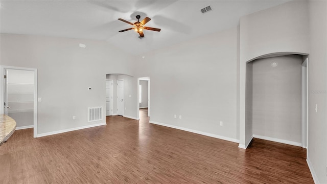 4143 Red Fern Ln, Lakeland, FL 33811 - empty room featuring arched walkways, ceiling fan, wood finished floors, and vaulted ceiling