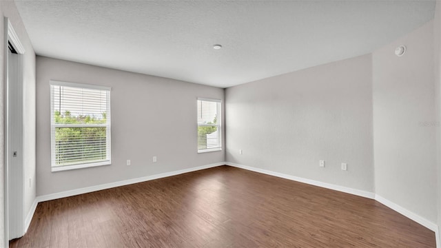 4143 Red Fern Ln, Lakeland, FL 33811 - spare room featuring dark wood-style floors, a smoke detector, and a textured ceiling