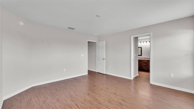 4143 Red Fern Ln, Lakeland, FL 33811 - unfurnished bedroom with wood finished floors and connected bathroom