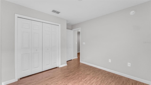 4143 Red Fern Ln, Lakeland, FL 33811 - unfurnished bedroom with light wood-style flooring and a closet