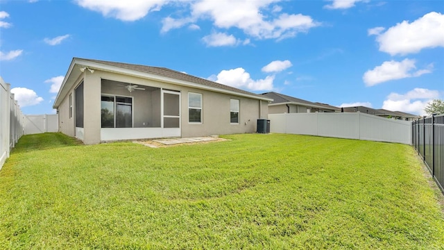 4143 Red Fern Ln, Lakeland, FL 33811 - back of house with stucco siding, a fenced backyard, a ceiling fan, and a sunroom