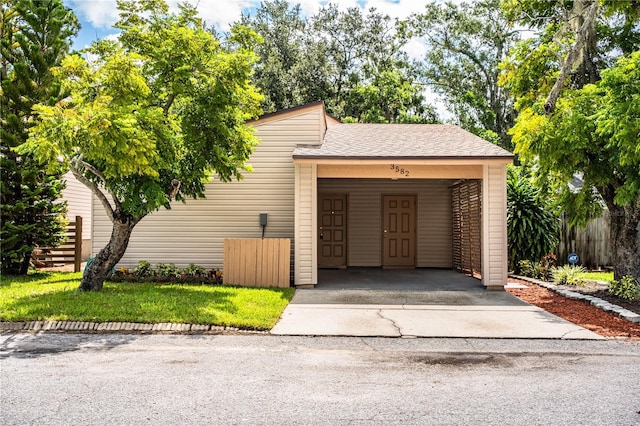 3582 Raintree Ct, Lakeland, FL 33803 - view of front facade with asphalt driveway, an attached carport, and roof with shingles
