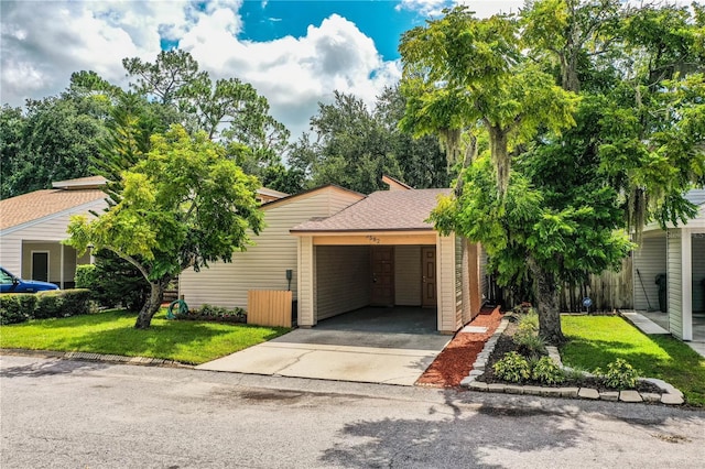3582 Raintree Ct, Lakeland, FL 33803 - obstructed view of property with driveway, a front lawn, and a carport