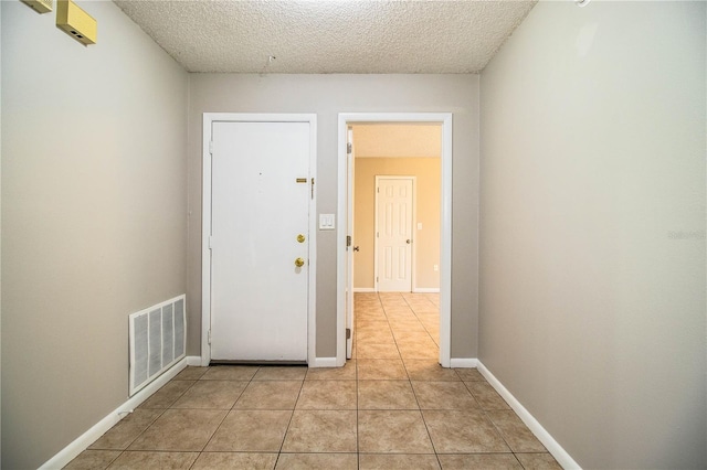3582 Raintree Ct, Lakeland, FL 33803 - corridor with a textured ceiling and light tile patterned floors