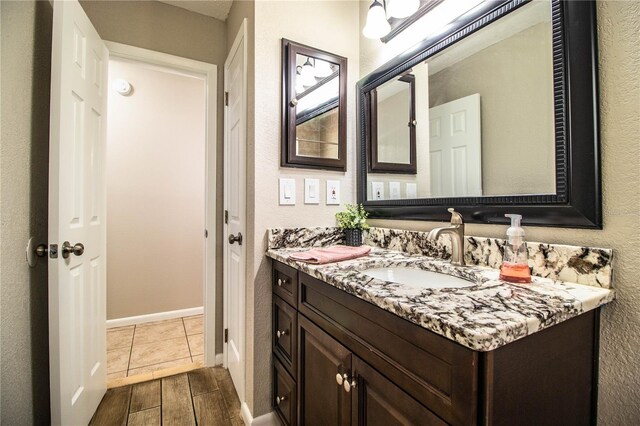 3582 Raintree Ct, Lakeland, FL 33803 - bathroom with vanity, wood finished floors, and a textured wall