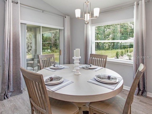 1496 Fleur Dr, Davenport, FL 33837 - dining room with wood finished floors, plenty of natural light, vaulted ceiling, and a chandelier