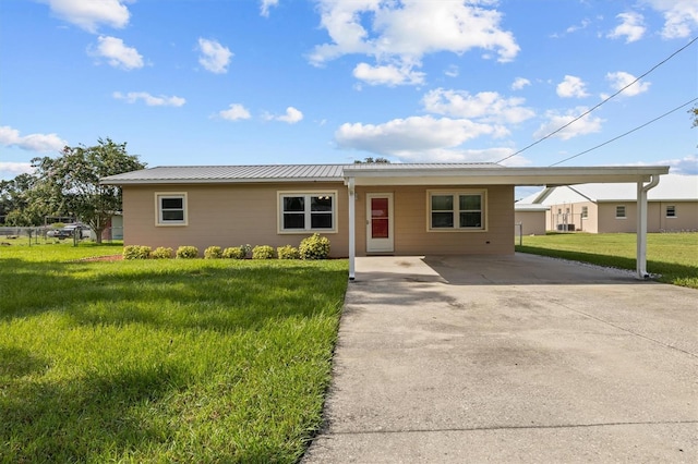 3521 Publix Rd, Lakeland, FL 33810 - ranch-style home with driveway, a carport, a front lawn, and a metal roof