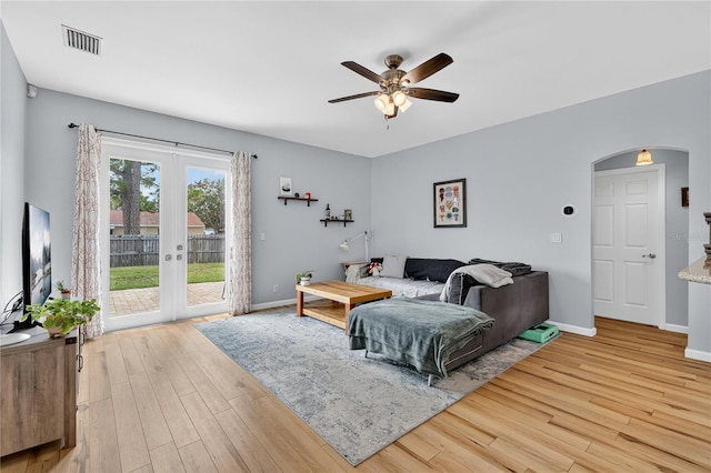 1026 Mohawk Ave NW, Palm Bay, FL 32907 - living room with french doors, arched walkways, wood finished floors, and ceiling fan