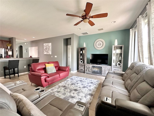 13303 Moss Park Ridge Dr, Orlando, FL 32832 - living room featuring ceiling fan, light tile patterned flooring, recessed lighting, and arched walkways