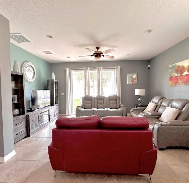 13303 Moss Park Ridge Dr, Orlando, FL 32832 - living room featuring light tile patterned flooring, ceiling fan, and a textured ceiling