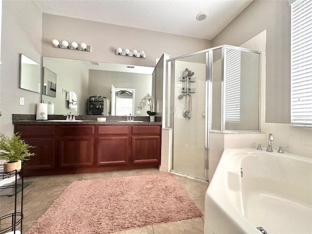 13303 Moss Park Ridge Dr, Orlando, FL 32832 - bathroom featuring a garden tub, a stall shower, double vanity, tile patterned flooring, and a textured ceiling
