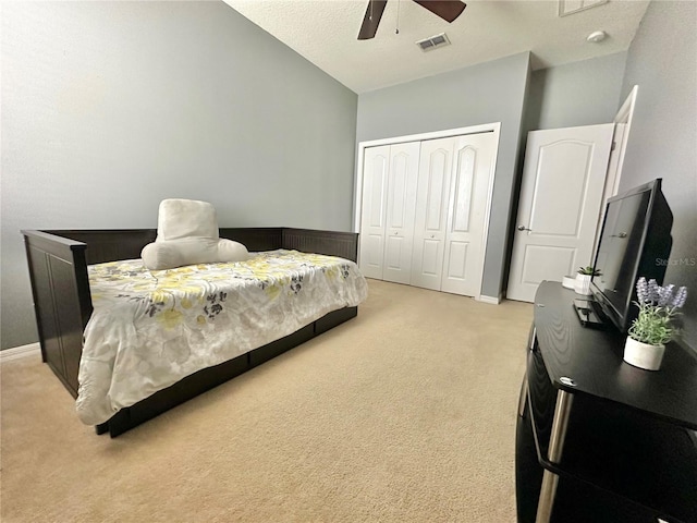 13303 Moss Park Ridge Dr, Orlando, FL 32832 - bedroom featuring light colored carpet, a closet, a ceiling fan, and vaulted ceiling