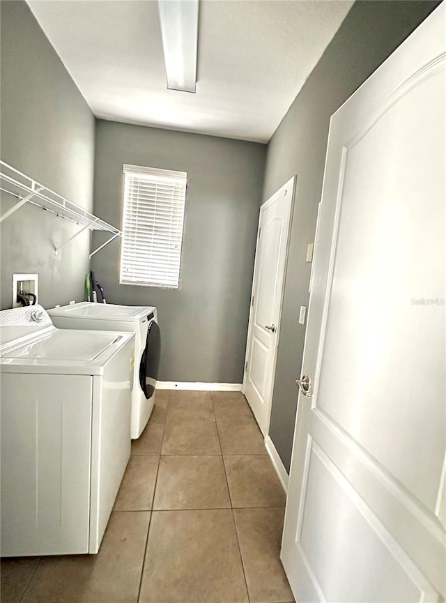 13303 Moss Park Ridge Dr, Orlando, FL 32832 - laundry room featuring washer and clothes dryer and light tile patterned floors