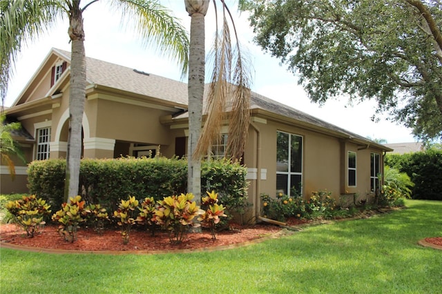 3023 Northfield Dr, Tarpon Springs, FL 34688 - rear view of house featuring stucco siding, a lawn, and a chimney
