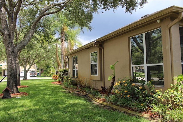 3023 Northfield Dr, Tarpon Springs, FL 34688 - view of side of property featuring stucco siding and a yard