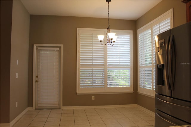 3023 Northfield Dr, Tarpon Springs, FL 34688 - unfurnished dining area featuring a chandelier and light tile patterned flooring