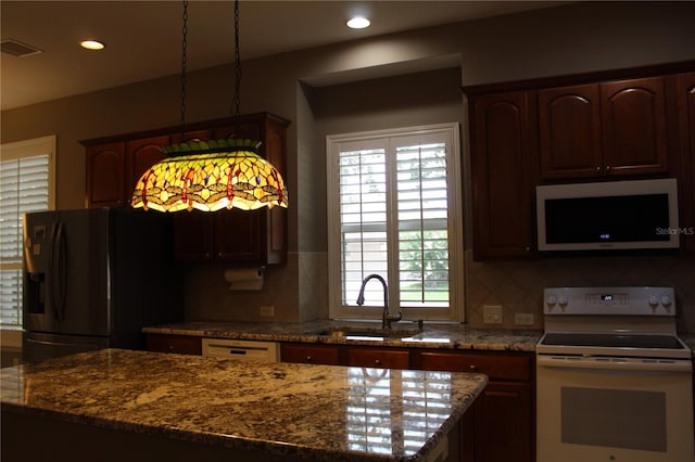 3023 Northfield Dr, Tarpon Springs, FL 34688 - kitchen with white electric range oven, fridge with ice dispenser, dark stone counters, tasteful backsplash, and recessed lighting