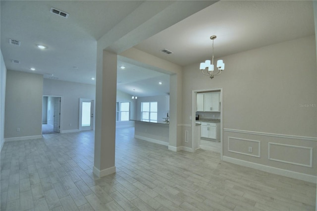 5427 Waterside Dr, Auburndale, FL 33823 - unfurnished room with a chandelier, light wood-type flooring, and recessed lighting