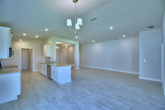 5427 Waterside Dr, Auburndale, FL 33823 - kitchen with appliances with stainless steel finishes, open floor plan, white cabinets, recessed lighting, and a chandelier