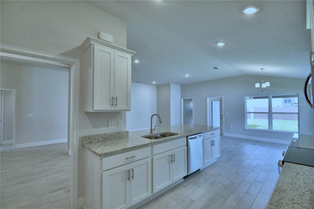 5427 Waterside Dr, Auburndale, FL 33823 - kitchen with dishwashing machine, white cabinets, light stone counters, a chandelier, and lofted ceiling