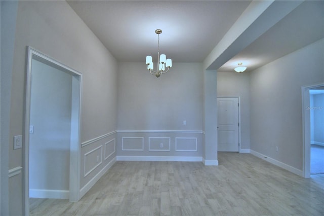 5427 Waterside Dr, Auburndale, FL 33823 - spare room with light wood finished floors and a chandelier