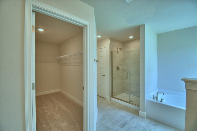 5427 Waterside Dr, Auburndale, FL 33823 - full bath featuring a stall shower, a bath, and a walk in closet