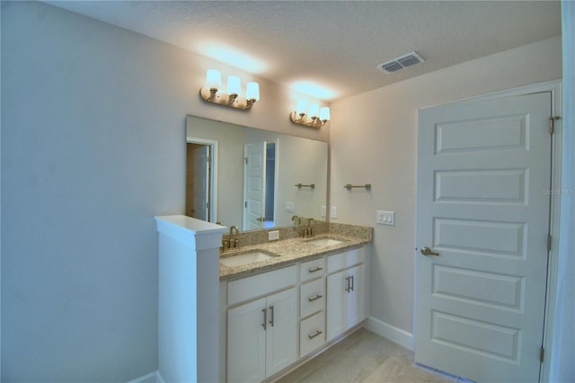 5427 Waterside Dr, Auburndale, FL 33823 - bathroom featuring double vanity and a textured ceiling